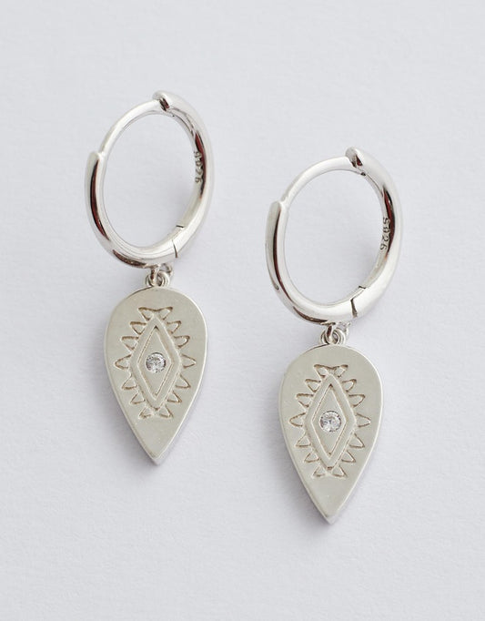 aurora huggie earrings silver flay lay