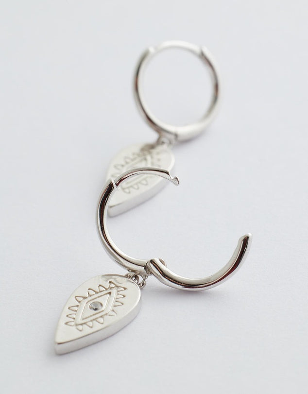 aurora huggie earrings silver flay lay side view