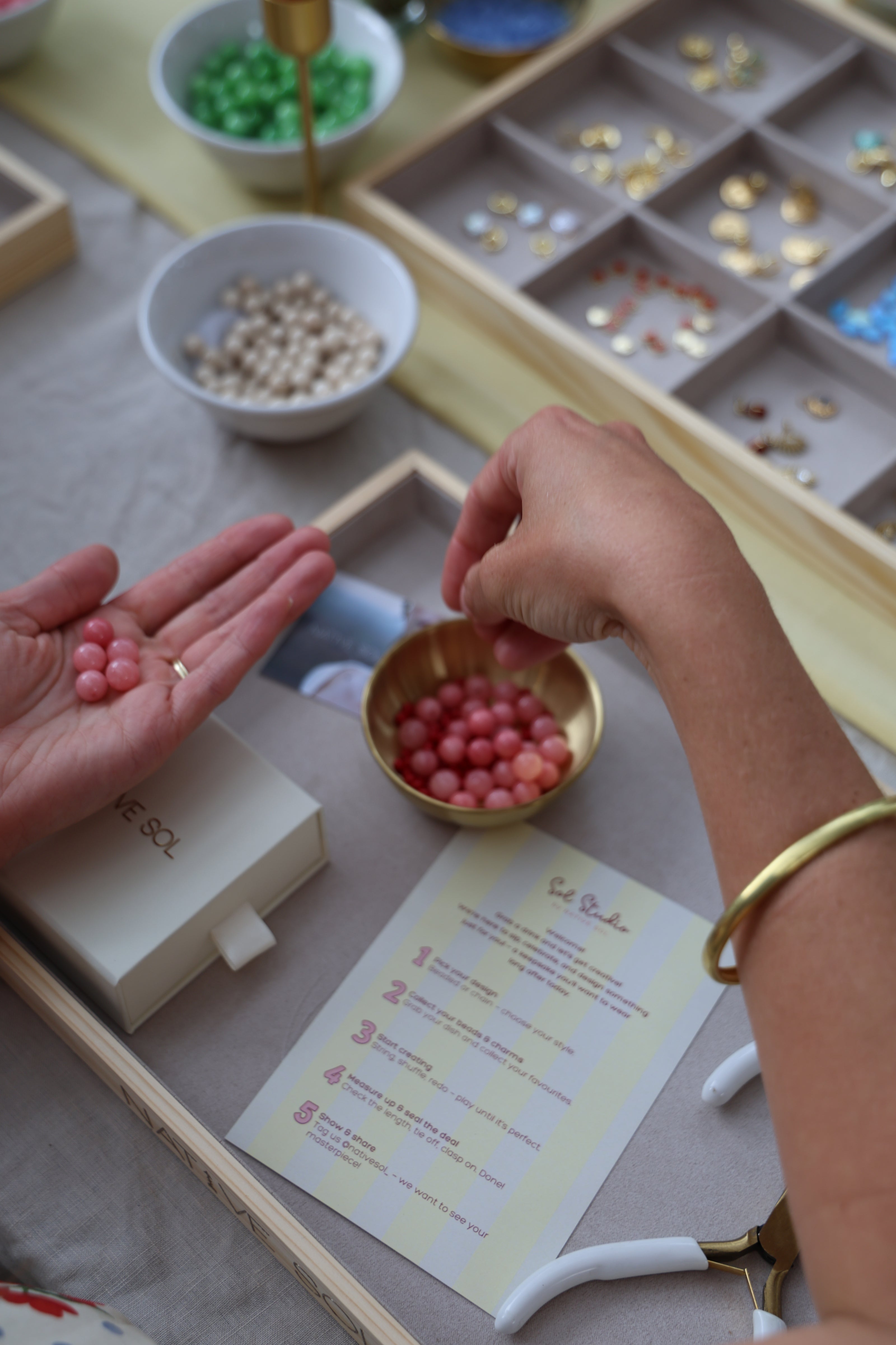 person making jewellery at a necklace making workshop