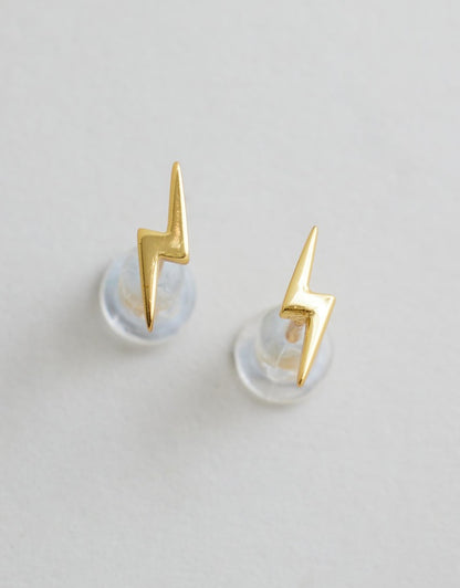 Lightning Bolt Studs - Gold flat lay on grey background