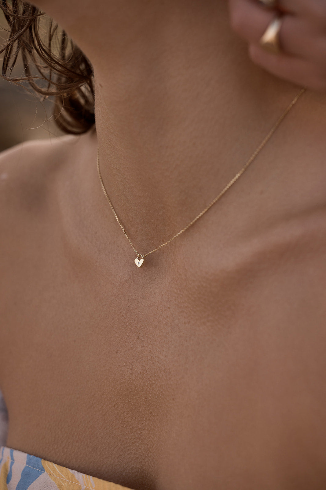 solstice heart necklace on model close up front