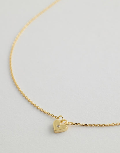 solstice heart necklace close up flay lay