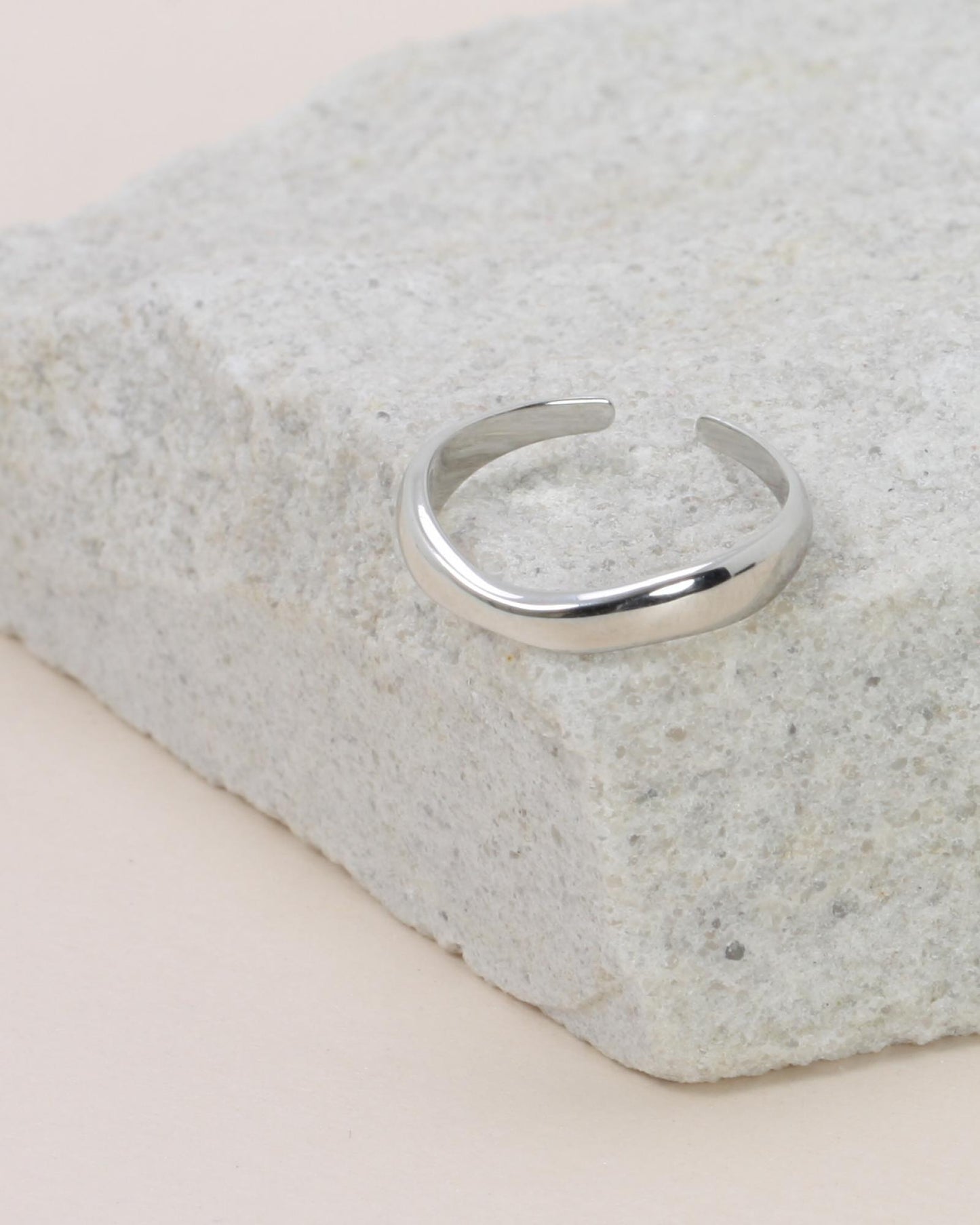 Hannah Wave Ring - Silver on a grey rock