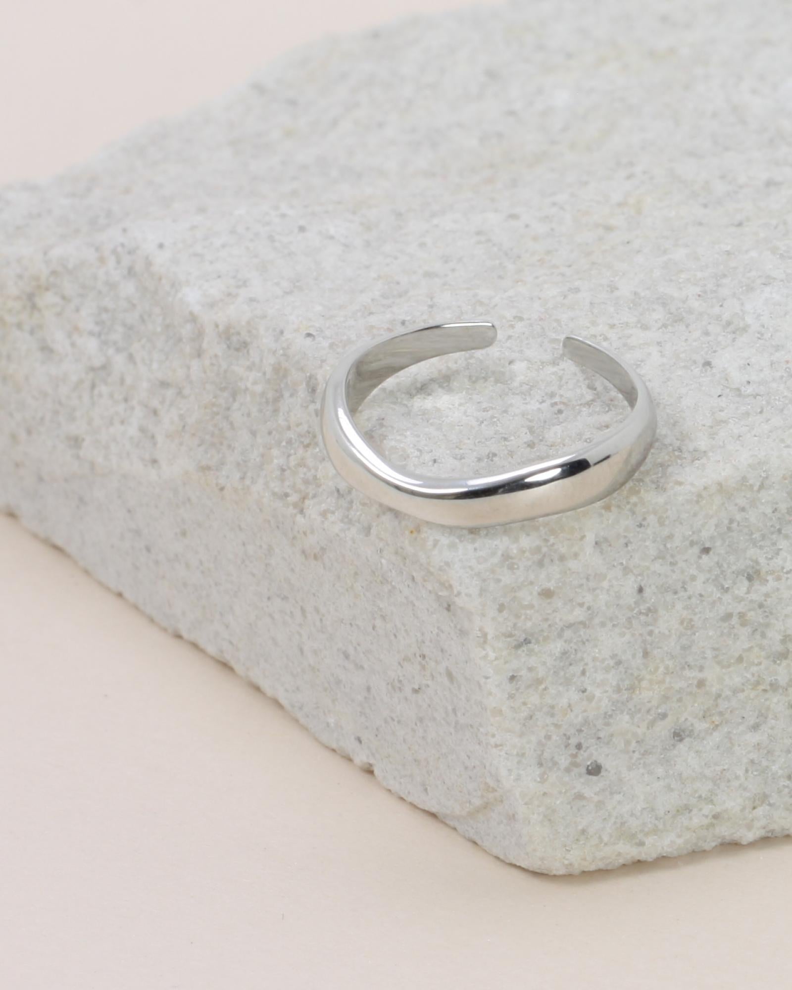 Hannah Wave Ring - Silver on a grey rock