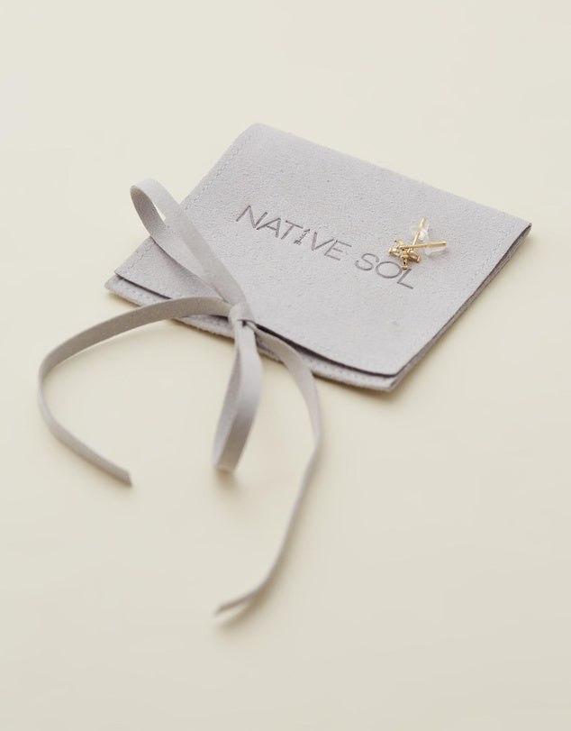 Lily Studs - Gold laid out on jewellery branded pouch