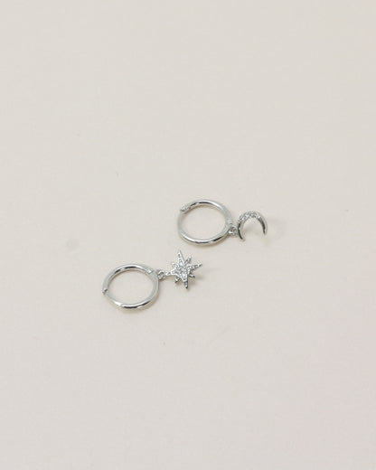 Night Sky Huggies - Silver flat lay on beige background