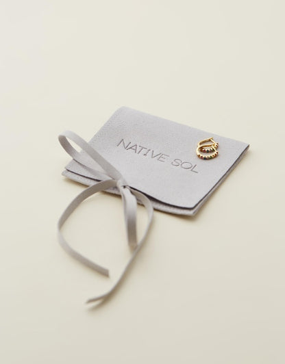 Rio Rainbow Huggies laid out on branded jewellery pouch