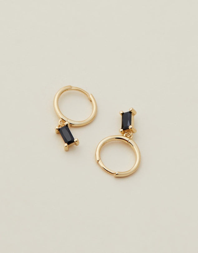 Rita Huggies - Black & Gold flat lay on beige back ground