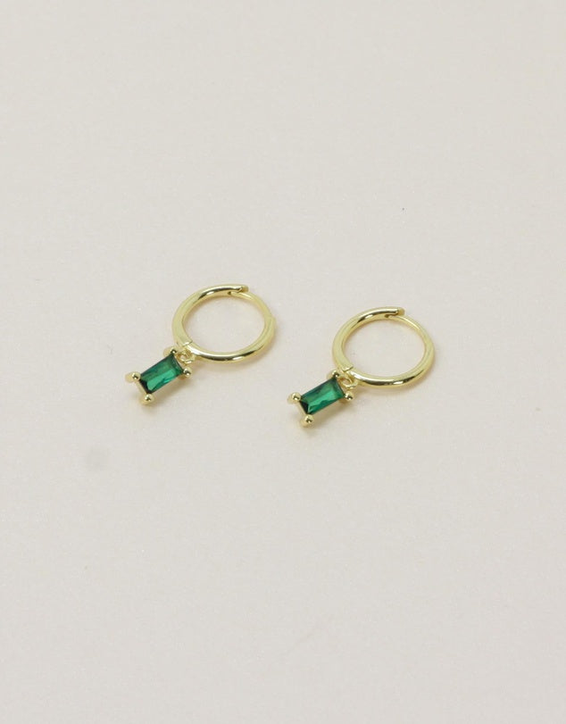 Rita Huggies - Emerald & Gold flat lay on a beige background