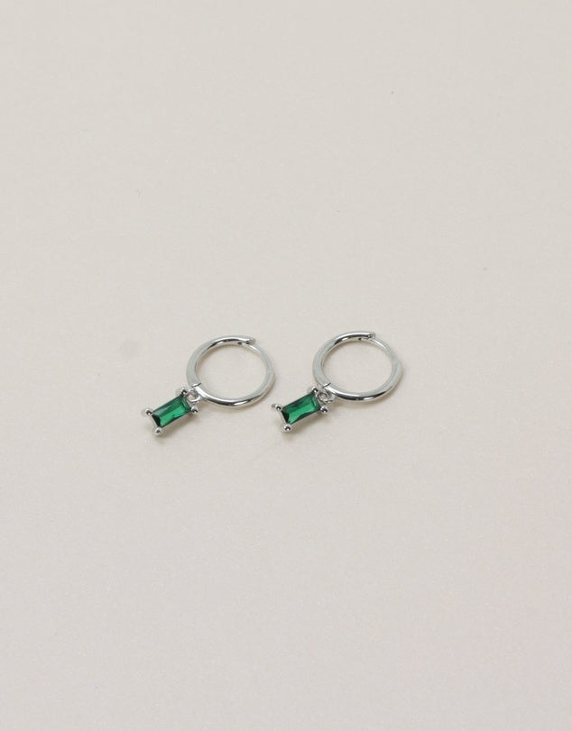 Rita Huggies - Emerald & Silver flat lay on beige background