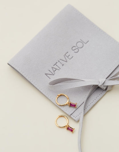 Rita Huggies - Pink & Gold laid out on branded jewellery pouch