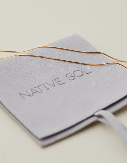 Snake Chain gold laid out on the branded packaging
