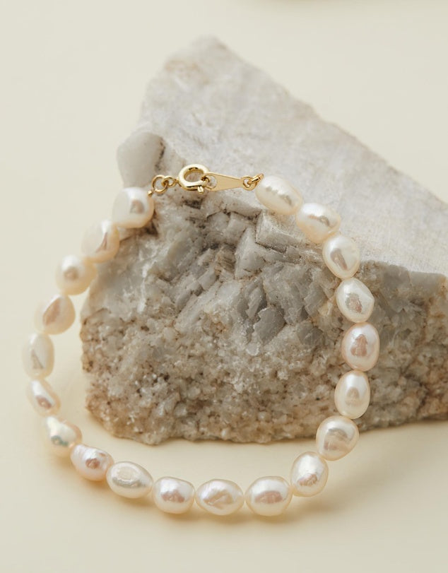 Sophia Pearl Bracelet close up against a beige rock